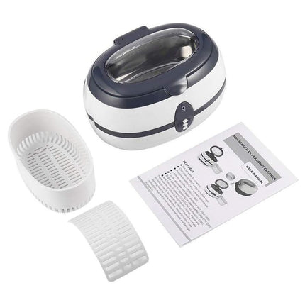 Ultrasonic cleaner with accessories and user manual on a white background