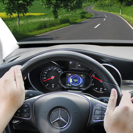 Person driving a car with a clear view of the dashboard and road ahead.