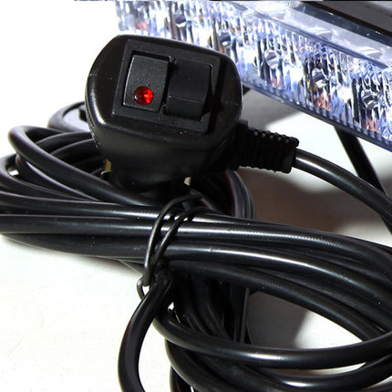 A black electrical power cord with a UK three-pin plug and a small red indicator light, coiled on a white surface next to a clear LED light bar.