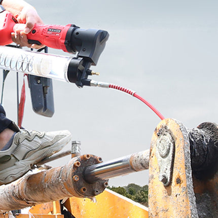 Person using a power tool on a construction site with a clear sky background