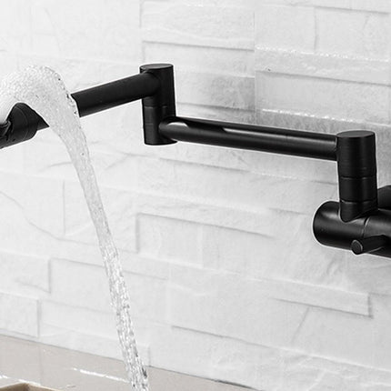 A matte black wall-mounted kitchen faucet with a curved spout and waterfall-style water flow, shown against a white subway-tile backsplash.