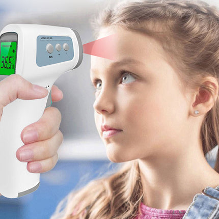 Infrared thermometer being used on a child's forehead