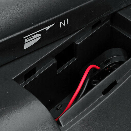 Close-up of a black electronic device with a red wire, featuring a brand logo.