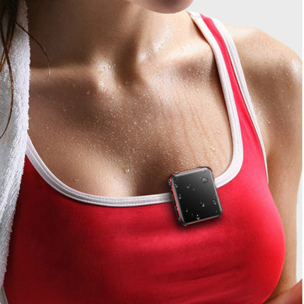 A close-up of a woman's chest wearing a red athletic tank top with white trim and a small black rectangular chest-mounted device attached near the neckline.