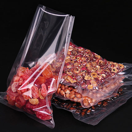 Clear plastic bags filled with various types of snacks on a black background