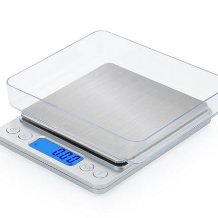 Digital kitchen scale with a clear lid on a white background