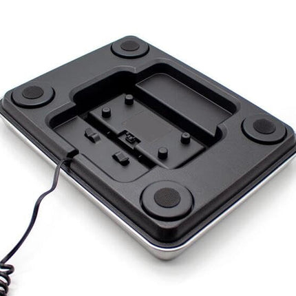 Black electronic device with buttons and a cord on a white background