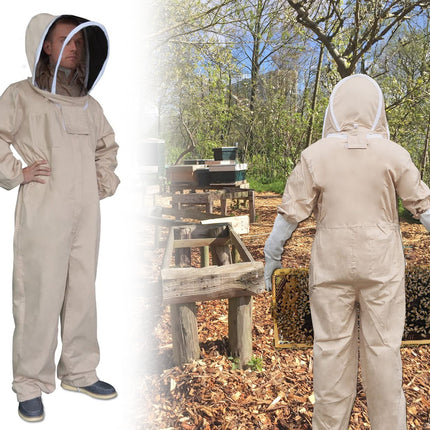 Person wearing a beekeeping suit with a hood, standing outdoors near beehives.