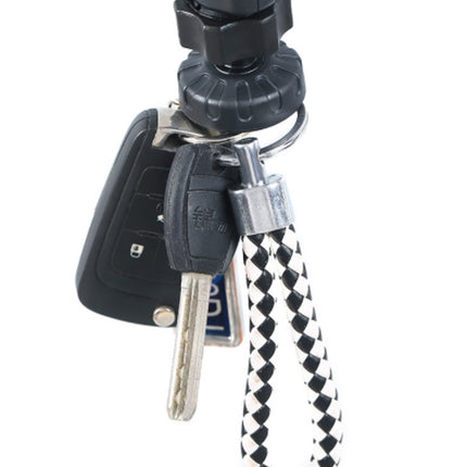 Keychain with car keys and a black and white braided cord on a white background