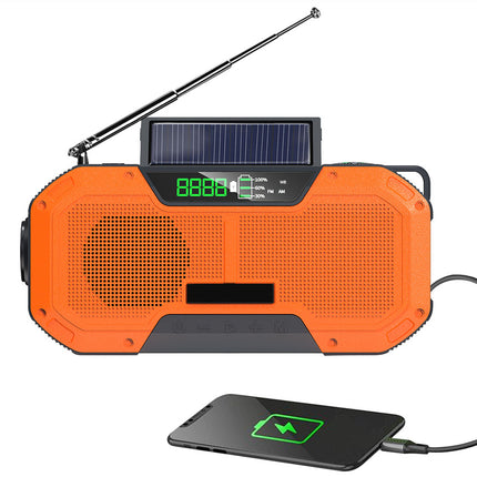 Orange solar-powered radio with USB charging pad on a white background