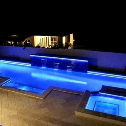 Modern outdoor pool with illuminated edges at night