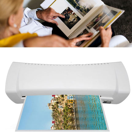 A white flatbed photo printer shown with an open photo album above it and a colorful landscape print emerging from the bottom, on a white background.