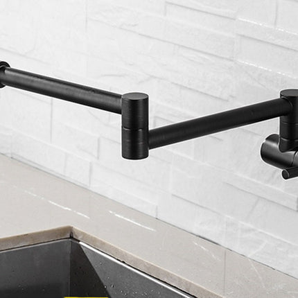 A matte black wall-mounted adjustable kitchen faucet with a long horizontal spout and side lever, shown with water running into a sink against a white subway tile backsplash.