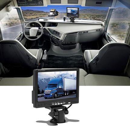 Interior of a vehicle with multiple monitors displaying truck images.