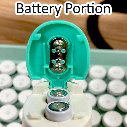 Close-up of a battery compartment with batteries inside, labeled 'Battery Portion', on a wooden surface.