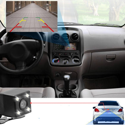 Car interior with a backup camera system displaying a rearview image.