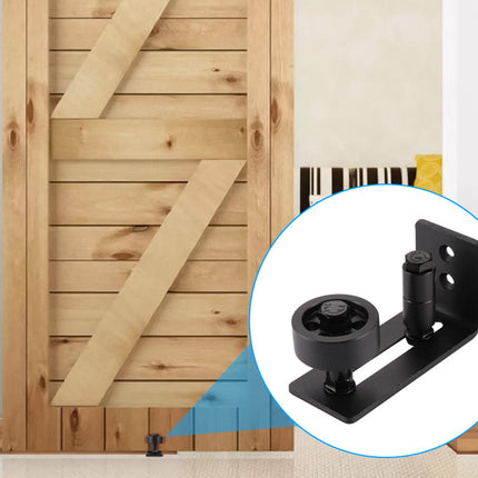 Wooden sliding barn door with a close-up of a black door roller mechanism.