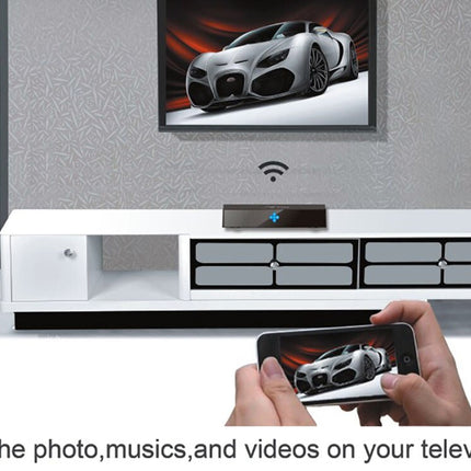 A wireless TV receiver device sits on a white media console beneath a television showing a sports car. In the foreground, hands hold a smartphone displaying the same car photo, with text at the bottom reading, 'Put the photo, musics, and videos on your television.