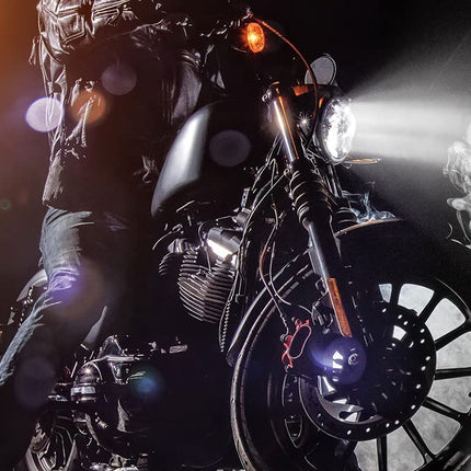 Person riding a motorcycle with a dark background