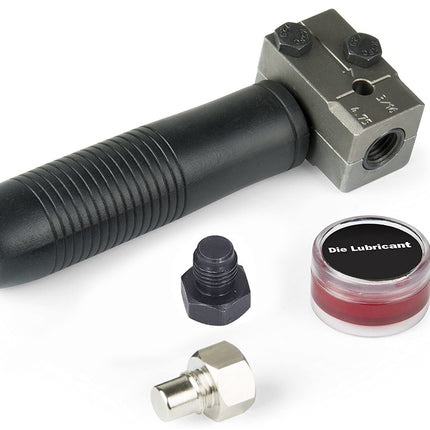 Tool kit with a black cylindrical tool, metal die, and small container of die lubricant on a white background.