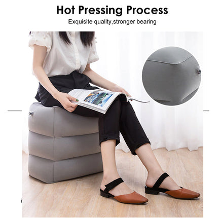 Person sitting on a gray cushioned stool reading a magazine with a ball in the background.