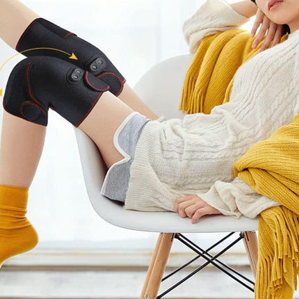 Person sitting on a chair wearing a black knee brace with buttons, yellow socks, and a yellow blanket.