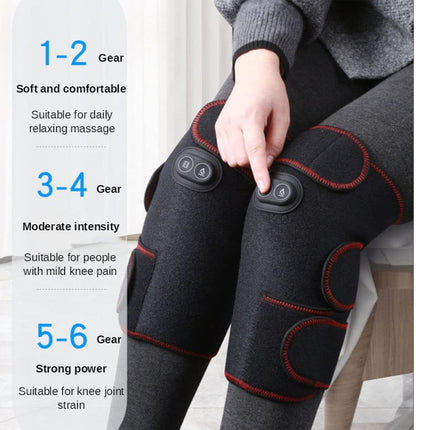 Person wearing electric knee massagers with gear level indicators on a white background
