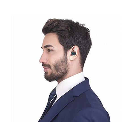 Man wearing a blue suit with a white shirt and black tie, listening to something on his ear.