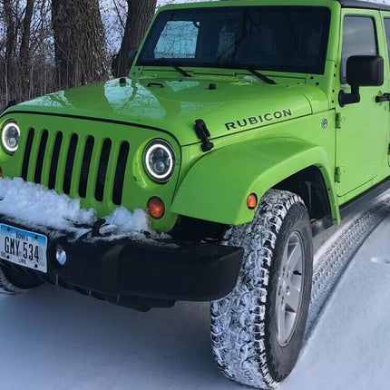 Green Jeep Rubicon in a snowy landscape