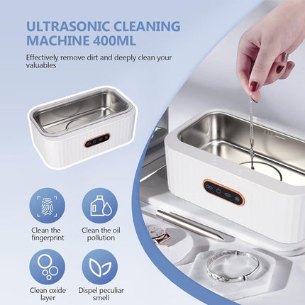 Ultrasonic cleaning machine with a hand using it, on a light blue background.