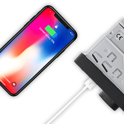Smartphone with charging cable connected to a power adapter on a white background