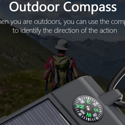 Outdoor compass with a person in the background on a mountain